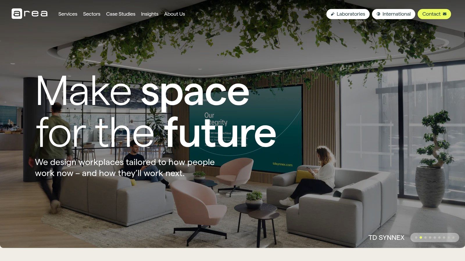 A modern, well-lit office breakout area designed by Area, featuring comfortable seating and collaborative spaces.