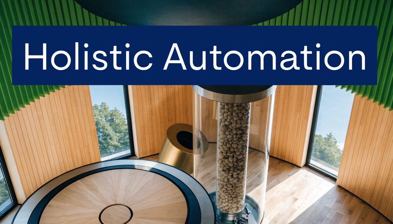A modern interior office space featuring a large glass cylinder filled with decorative rocks and furniture.
